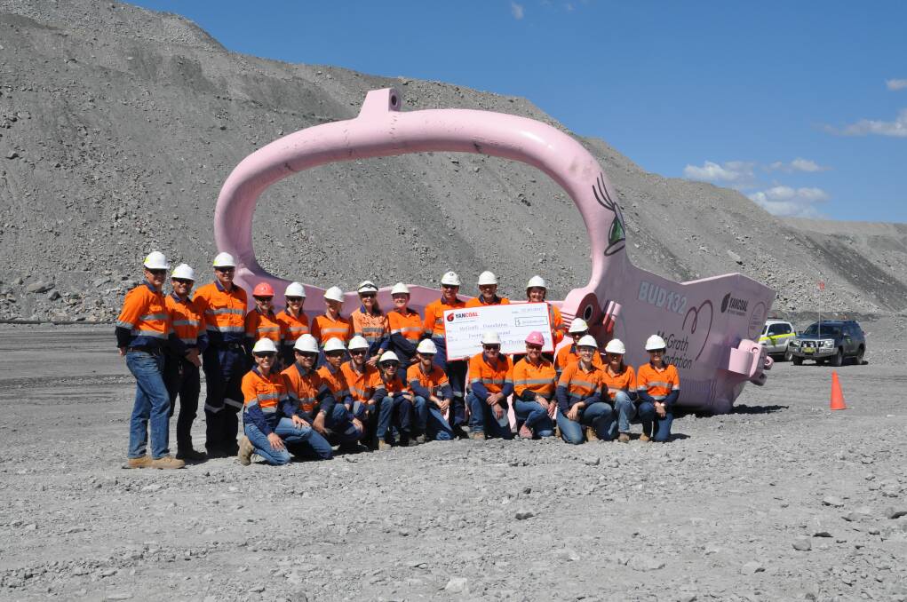 McGrath Foundation Breast Care Nurse Helen Moore with MTW Mining Manager Glenn Meyn and Yancoal employees join together to raise awareness of breast cancer and raise funds for the McGrath Foundation with the unveiling of a newly painted pink dragline bucket and a $20,000 donation.