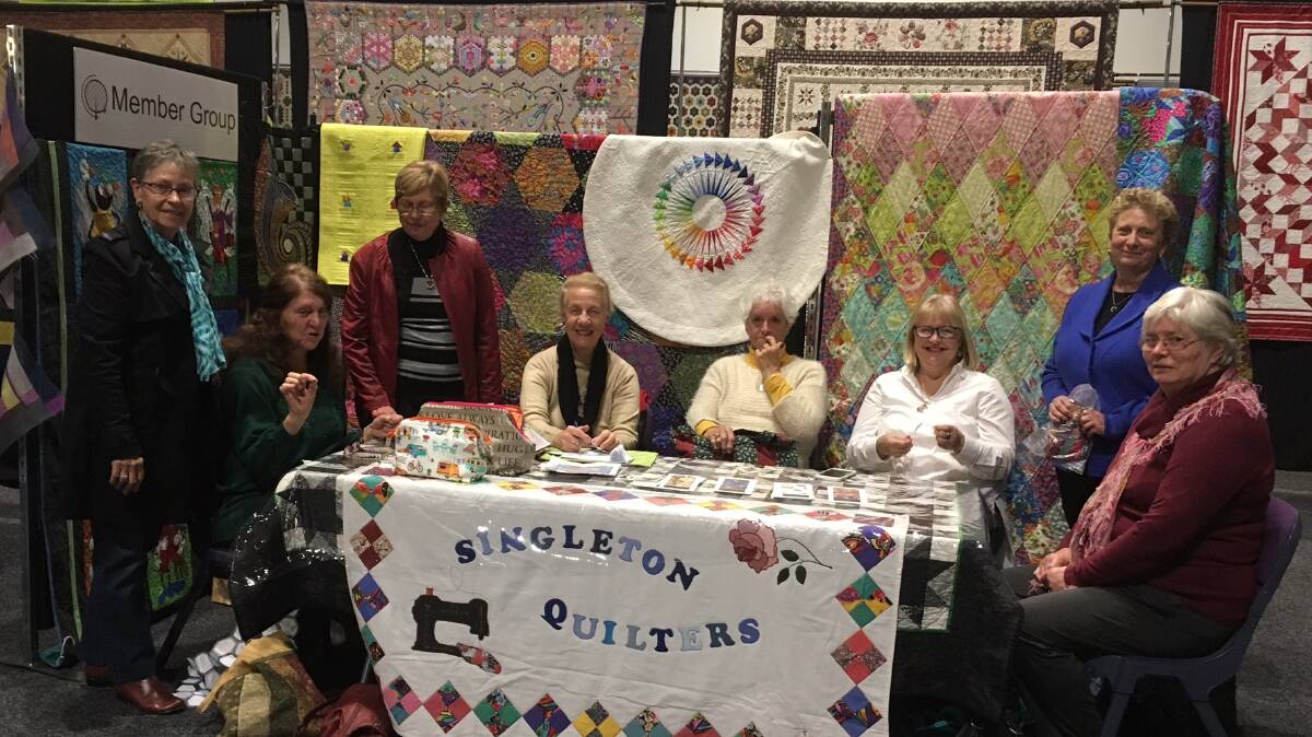 STITCHED TOGETHER: Some of the Singleton Quilters at their stand in the recent Sydney Quilt Show. 