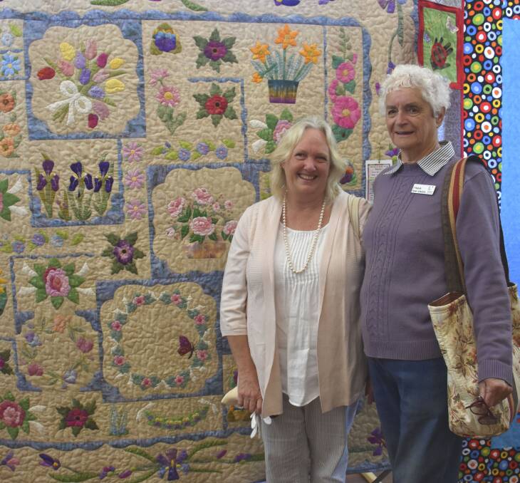 TALENT: Patchwork and quilting teacher Jenny Rofe with Betty Thompson in front of Betty's quilt. 