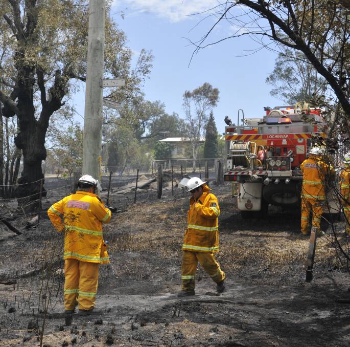 BUSHFIRE: RFS firefighters mopping up at the Camberwell grass fire that burnt very close to homes in the village.
