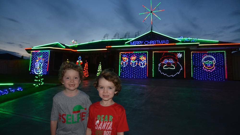 LITTLE HELPERS: Singleton siblings Callan and Aidyn Hannigan in front of their brightly decorated house.