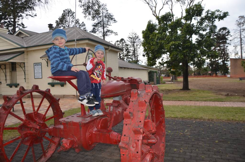 PLAYTIME: Brothers Henry and Oliver Short enjoy time on the vintage tractors in Burdekin Park. 