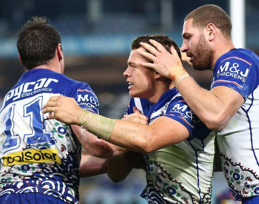 NEW HOME: Bulldogs winger Kerrod Holland, centre, celebrates after scoring a try against the North Queensland Cowboys in round 10 at ANZ Stadium. Picture: Getty Images