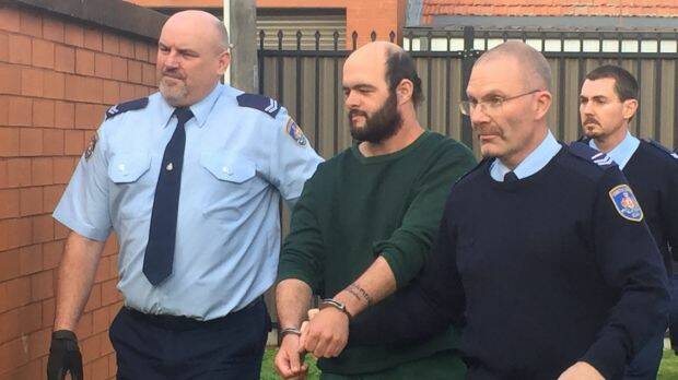 Marcus Stanford is escorted into Leeton Local Court.  Photo: Emma Partridge

