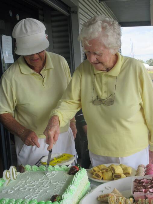 SWEET TREAT: Grace Brown cuts her birthday cake with the help of Branxton Croquet Club president Jacky McDonald.