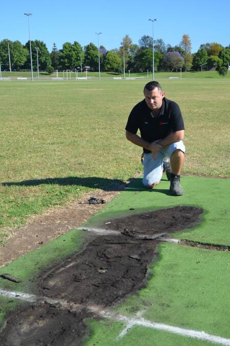 ANGRY: Singleton District Cricket Association president Tim Gore with the damaged pitch at Cook Park 5.