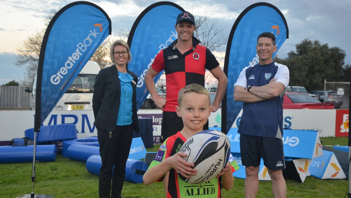 Greater Bank Singleton branch lending manager Kelly Hourn, Anthony Partridge and Todd Louden, with seven-year-old Eustie Bailey, at Rugby Park
