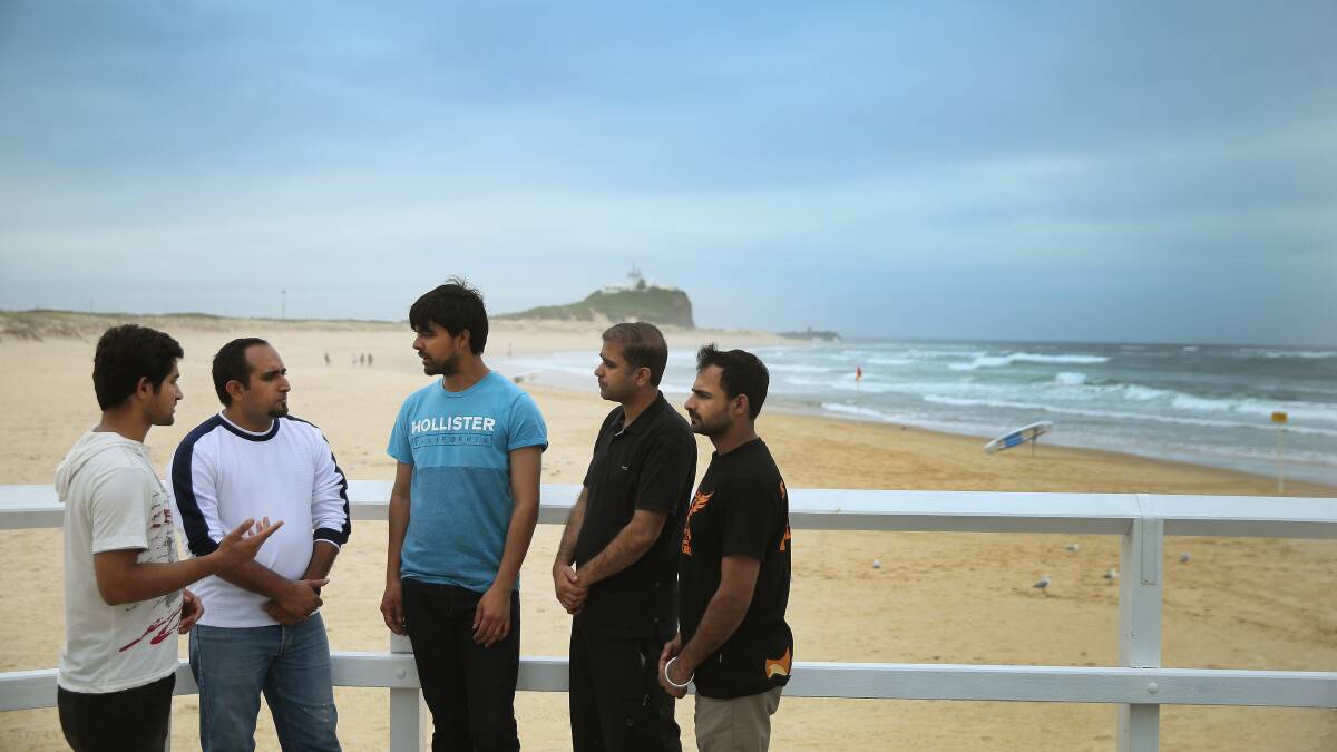 HOPE: Bilal Akram, centre, with other friends of missing University of Newcastle student Mohsin Awan. Picture: Marina Neil