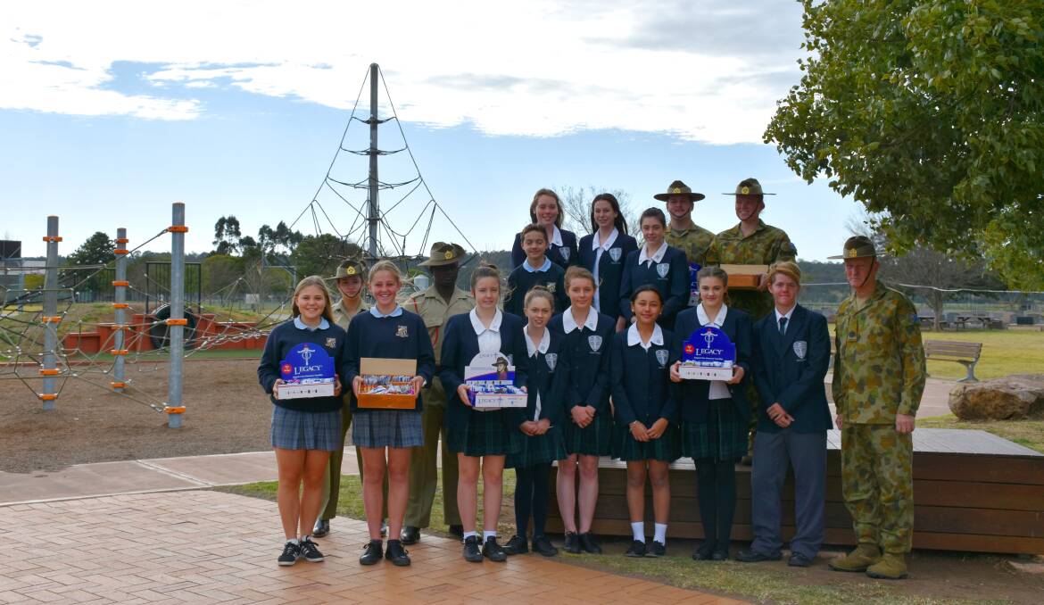 BADGE DAY: Singleton Legacy Group chairman Warrant Officer Class One Warren Barnes OAM pictured with students from St Catherine’s college, Singleton High School and soldiers from the School of Infantry.

