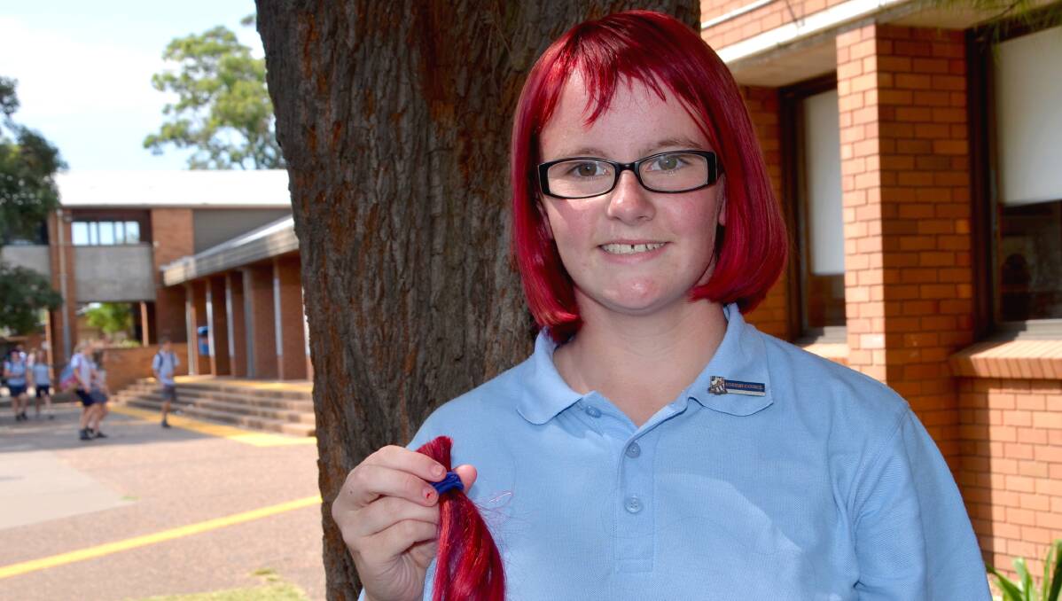 BRAVE DECISION: Samantha Odger holding her hair with pride after having it cut for the World's Greatest Shave. 
