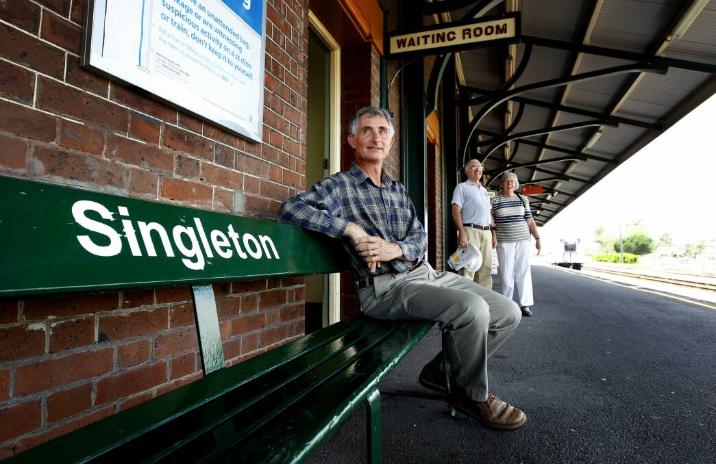 TWO MORE TRAINS: Singleton group members Martin Fallding with Phillip and Anne Boyd at Singleton train station in 2015. Photo by Dean Osland. 