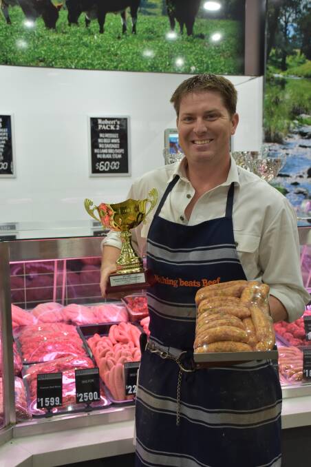 SECOND PLACE SNAG: Robert holding his award winning sweet curry lamb sausage. 