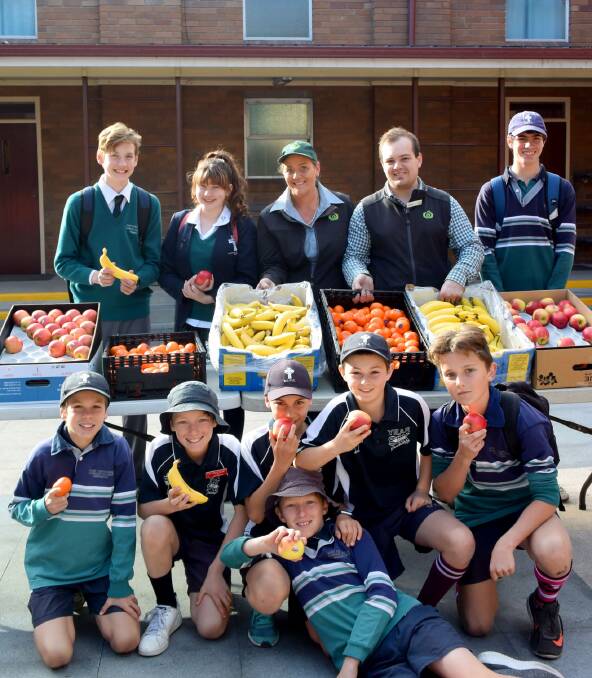 LOCAL SUPPORT: St. Catherine's students enjoyed fresh fruit thanks to Singleton Woolworths representatives, Alana Thompson and James Harragon. St. Catherine's will be running a range of activities as a part of Wellbeing Week.  