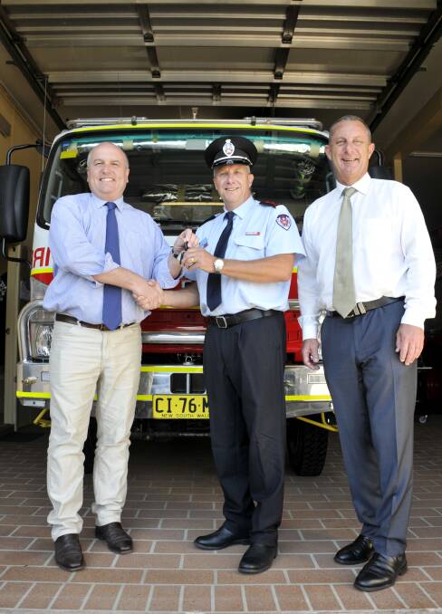 NEW TRUCK: Minister for Emergency Services David Elliot, Branxton and Greta Fire Station Captain Paul Scarce and Member for Upper Hunter Michael Johnsen. 