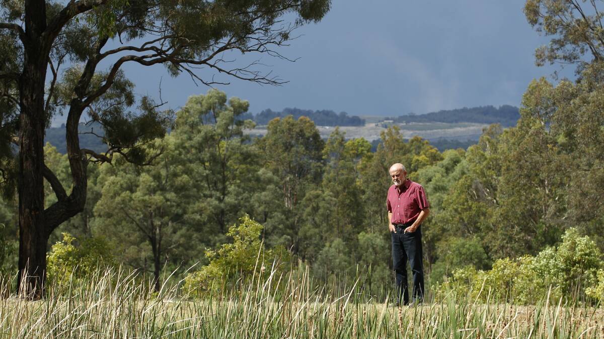 Angry: John Krey at his Bulga property with the Mount Thorley Warkworth mine in the background.
