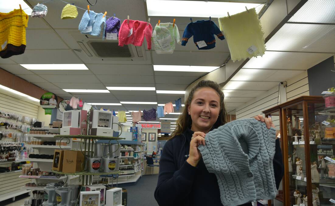 ALL SMILES: Guardian Angel Knitting Program coordinator Hollie Perkins with some of the donated items.