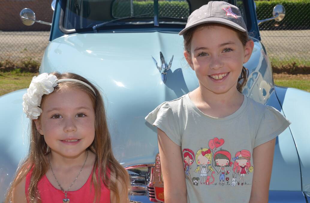 SIBLINGS:  Brianna and Alexandra Cooke admiring the vintage cars before heading over to the markets on Sunday.