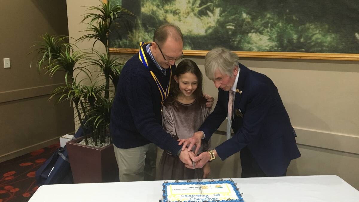 Club president Michael Titow, his daughter Lilly Titow and Rotary Past District Governor Brian Atkins.
