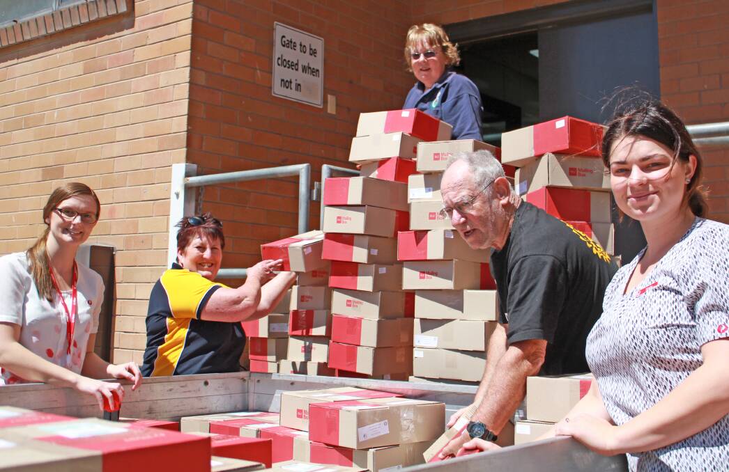 HUGE EFFORT: The girls from Australia post helping Ruth Rogers, Lyn and Bob Wood post the 200 care packages.
