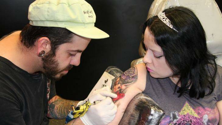 Tattoo artist John transforms Anastasia's angel into a possum. Photo: Supplied