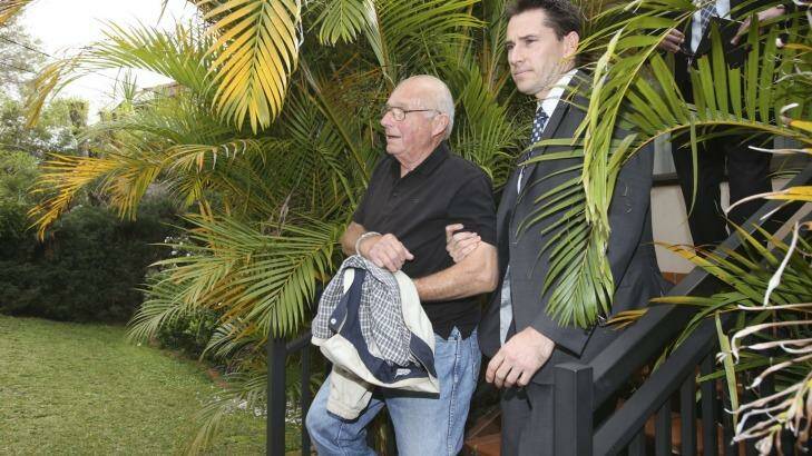 Detectives drag Roger Rogerson from his Padstow Heights home. Photo: Nick Moir