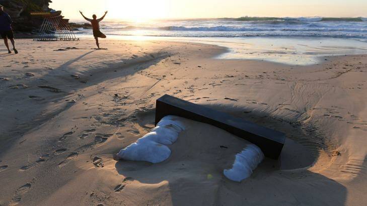 A Sculpture by the Sea artwork on Tamarama Beach remains buried on Tuesday morning. Photo: Peter Rae