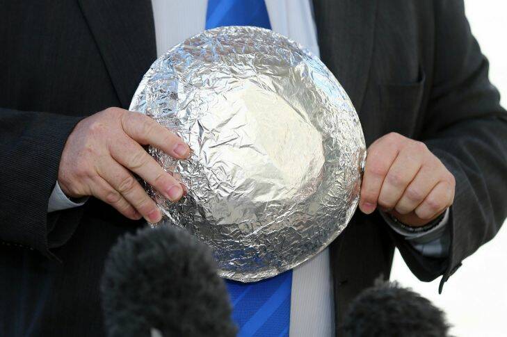 Labor MP Rob Mitchell brings a tinfoil that he made for Minister for Foreign Affairs Julie Bishop, during a doorstop interview at the House of Representatives doors at Parliament House in Canberra on Thursday 17 August 2017. fedpol Photo: Alex Ellinghausen