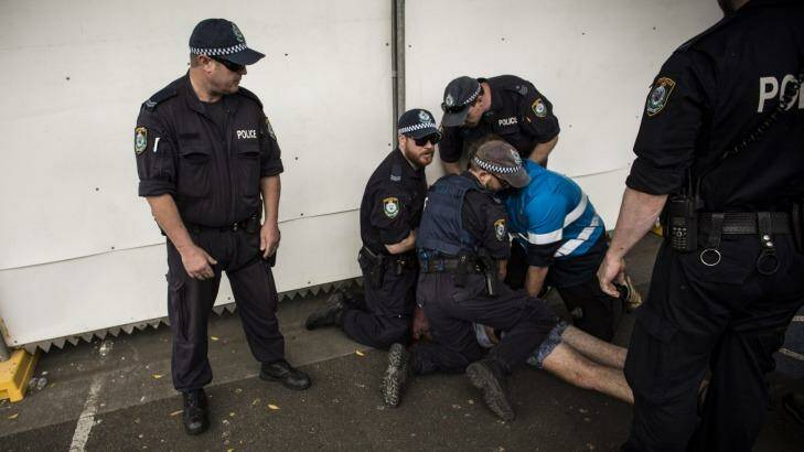 Police attend to a festivalgoer at Sydney Olympic Park. Photo: Dominic Lorrimer