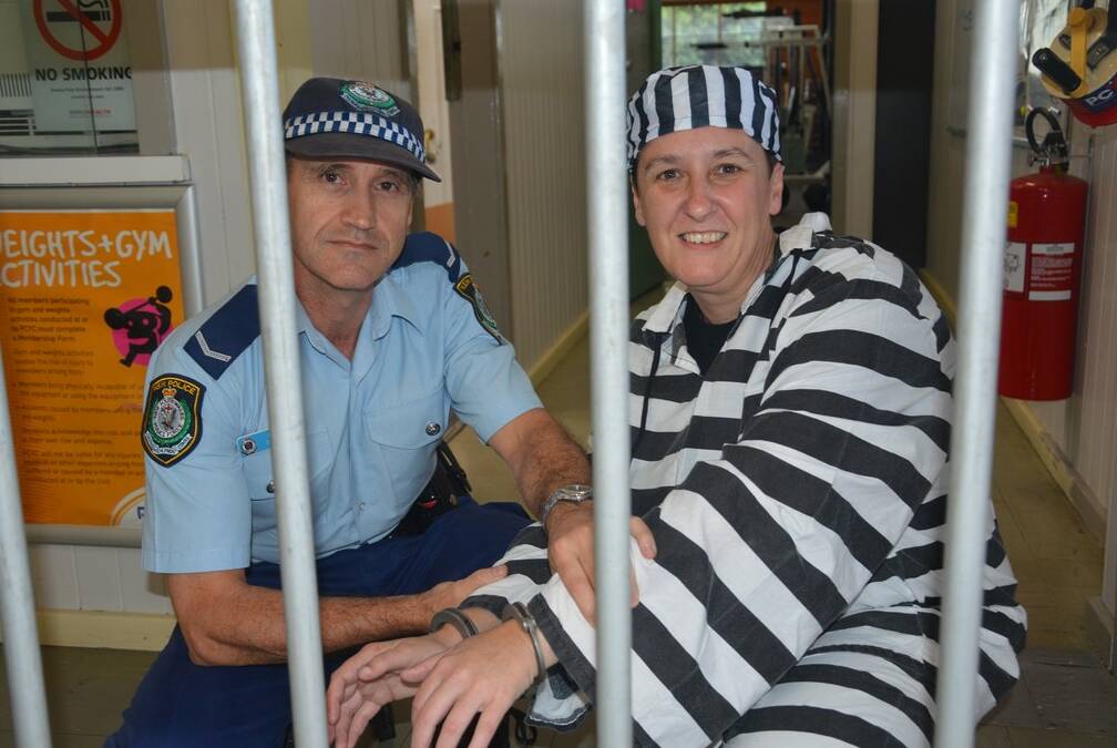 Police youth liaison officer constable Scott O'Riley handcuffs Singleton PCYC relieving manager Rebecca Loughton.
