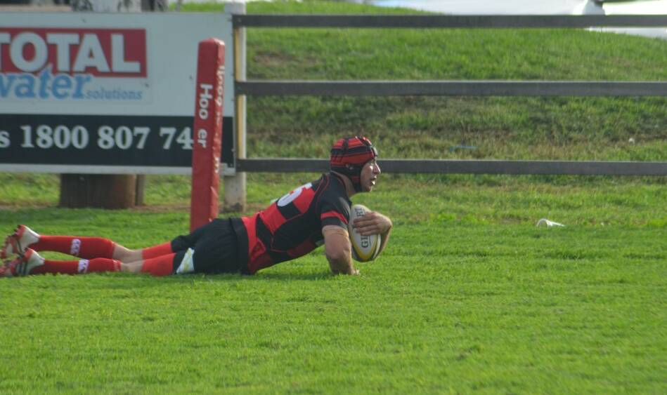 Daniel Bates goes over in the corner for the Bulls try against Southern Lakes.
