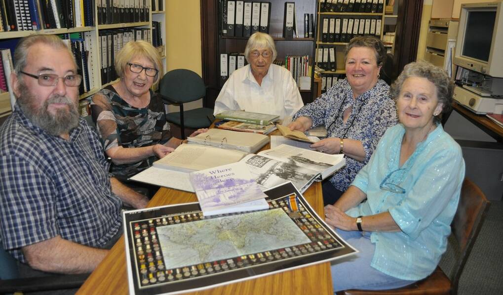 Military History: George Standen, Robyn Mackenzie, Valma Gee, Lyn MacBain and Miriam Knight looking over records at the Singleton Family History Society library.