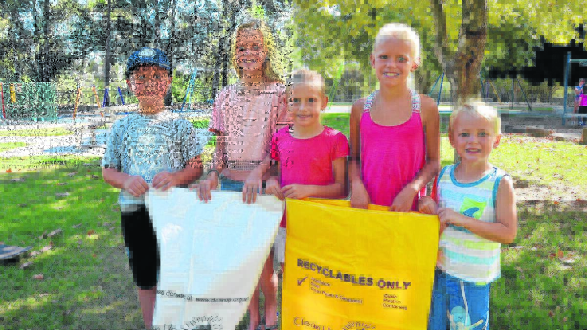 ENVIRONMENTAL HELPERS: Eli Rosic joins the Gradwell siblings Julia, Lara, Keira and Carter during Sunday’s Clean Up Australia Day at Rose Point Park.
