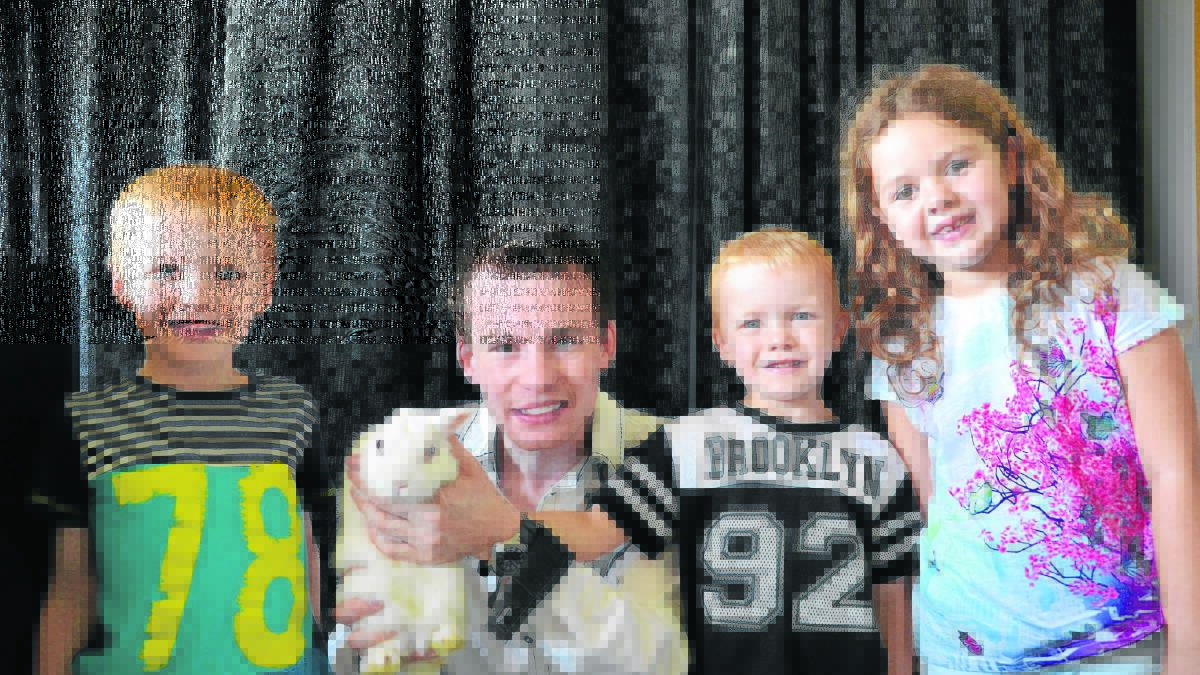 THE MAGIC BUNNY: Magician Joel Howlett with OOSH care students Patrick and Grant Fitzgerald and Charli Graham. 