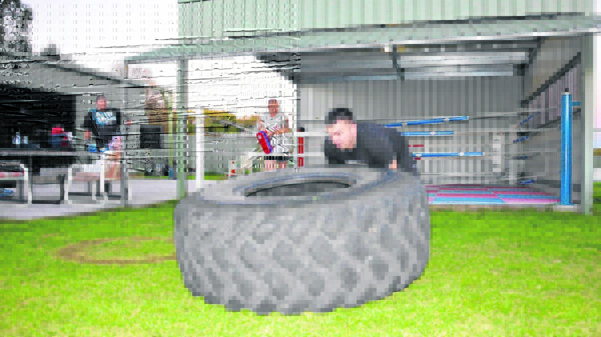 STRENGTH:  Blake Montgomery flips tyres at Hunter Muay Thai Singleton Australia. 