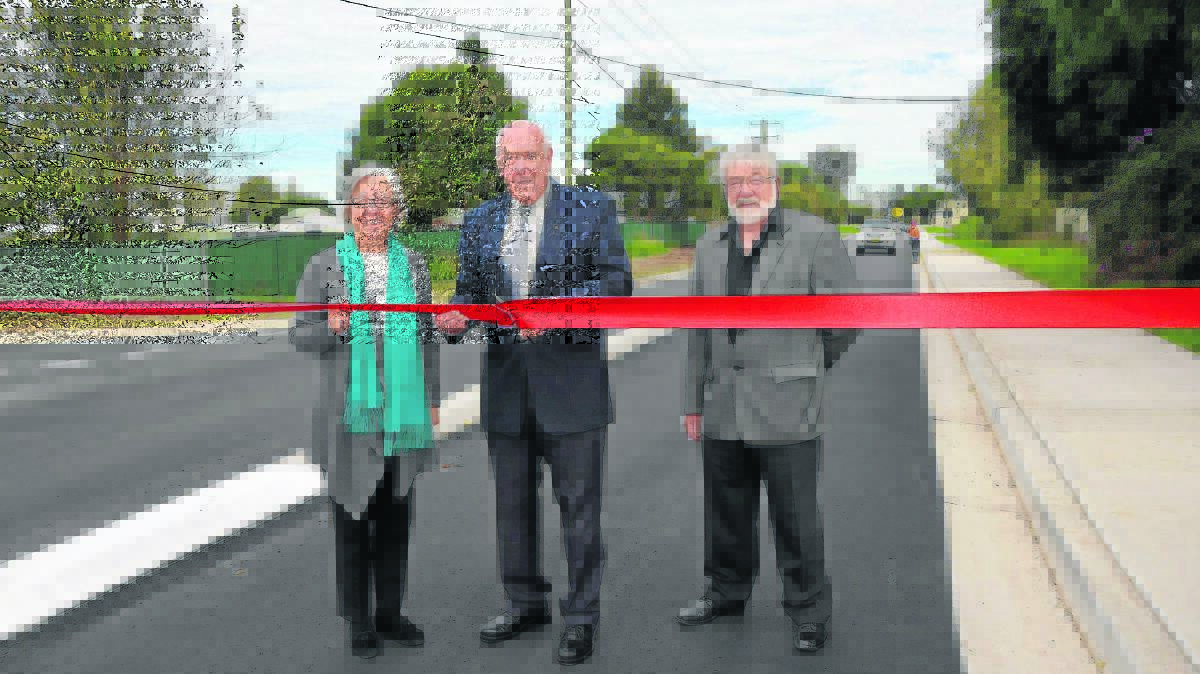 IT’S OFFICIAL: Singleton Council general manager Lindy Hyam, mayor John Martin and Cr Godfrey Adamthwaite at the opening of Dunolly Road on Wednesday.