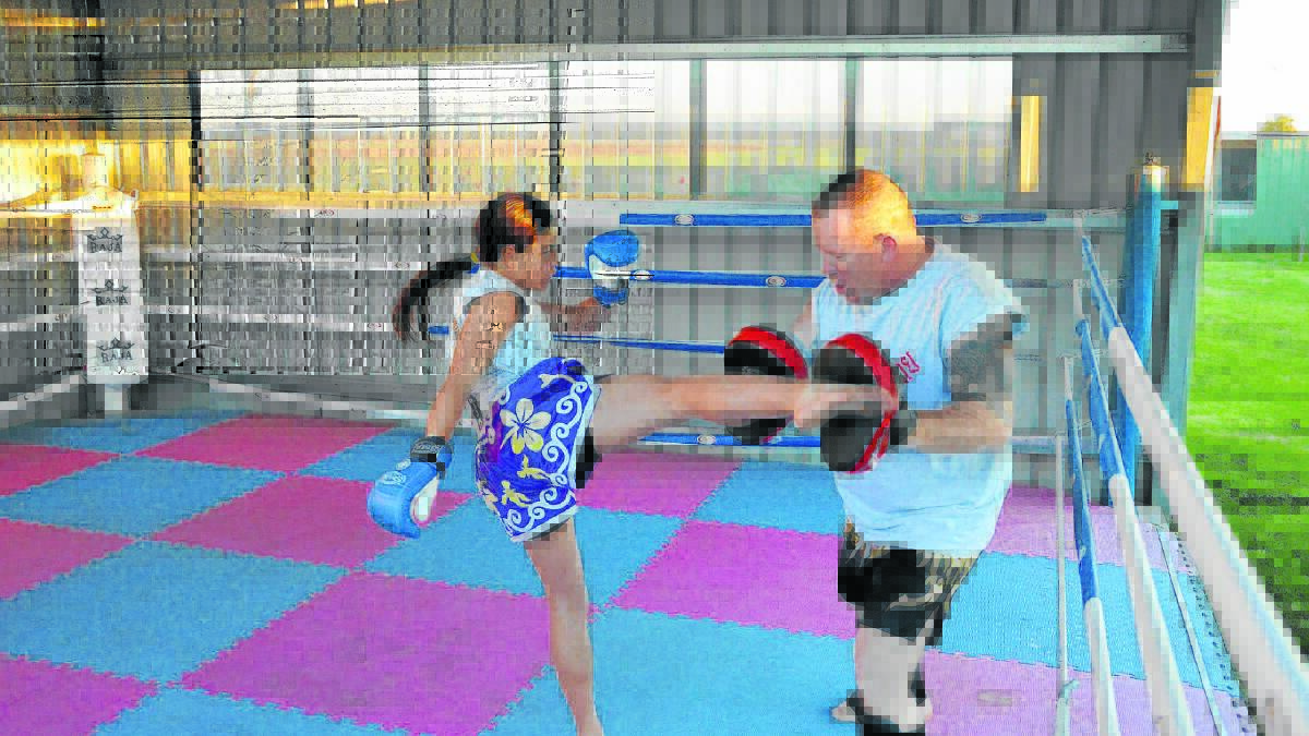 POWERFUL KICK: Kanisha Long trains with her father and shows her skills at Muay Thai. 
