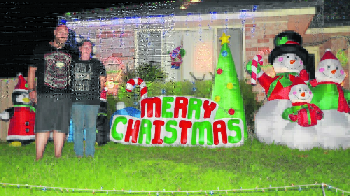 FESTIVE SPIRIT: Singleton couple Mark and Leanne Dennis outside their Christmas wonderland, which is located in Wilkinson Boulevard.
