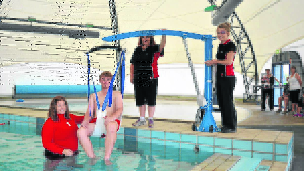 SWINGING INTO ACTION: (Left to right) YMCA staff Danielle Gilbert, Jack Mcmillan, Kristy Lambkin and Lauren Pitt test out the new mobility hoist. 