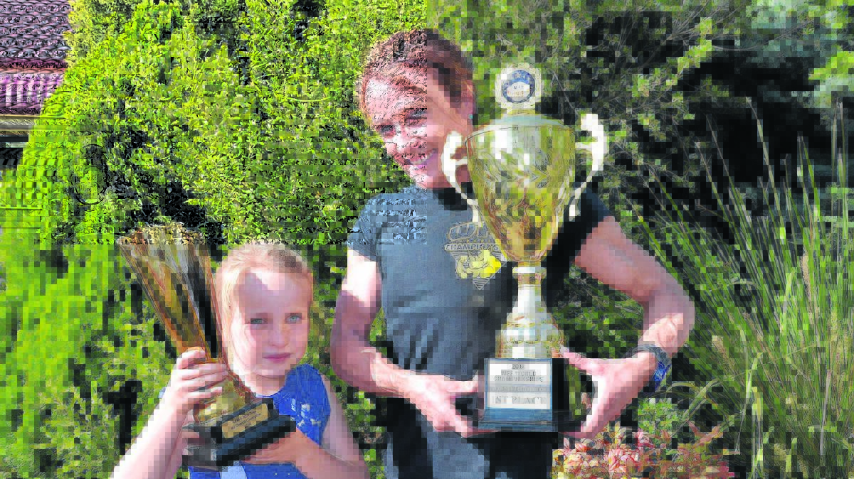 TROPHY HAUL: Annika Barnett and daughter Ella proudly show off the bodybuilder's championship rewards.