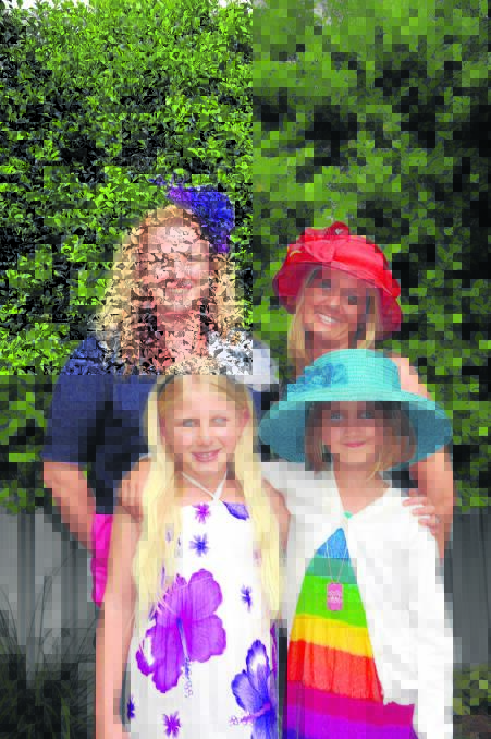 FASHIONS ON THE FIELD: Mums Holly Radmacher and Stacey Cox with their daughters, Faith and Emma, play dress-ups in readiness for the Melbourne Cup luncheon, in support of the Singleton Netball Association.
