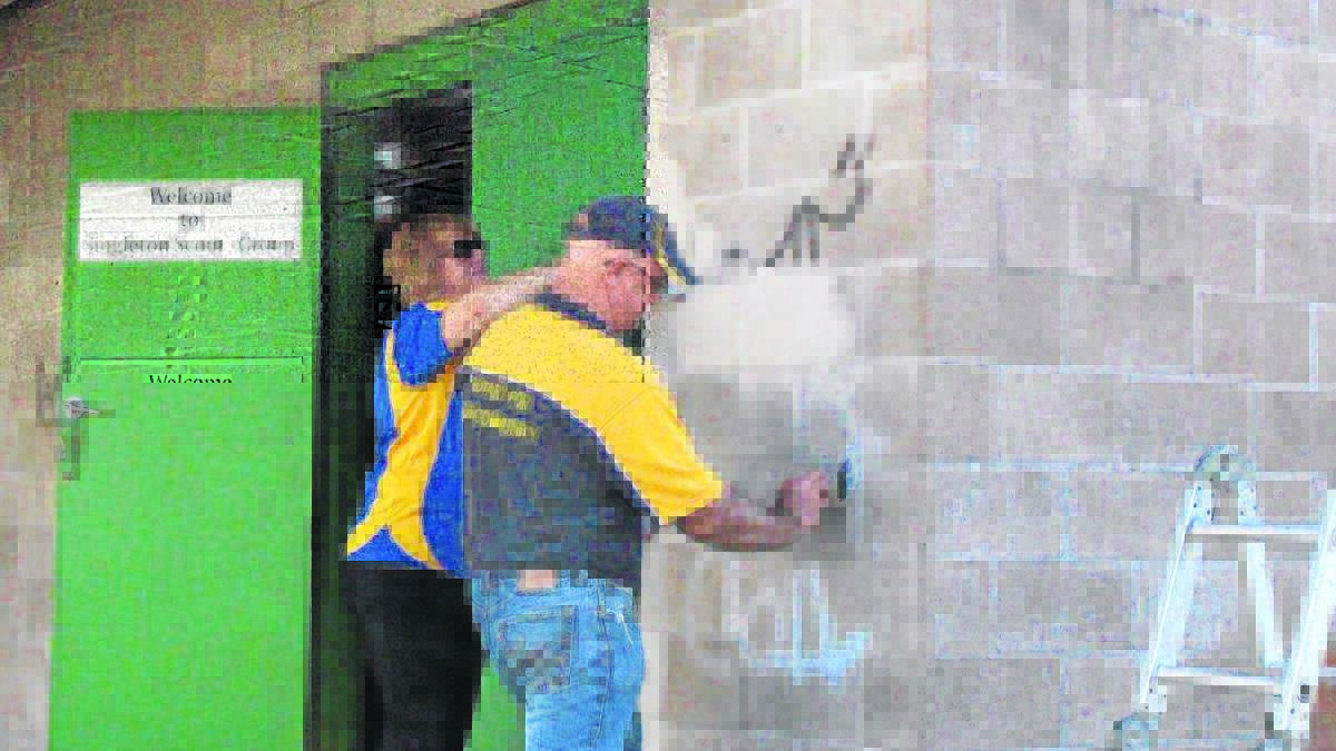 CLEAN UP: Megan Lobb (Singleton on Hunter Rotary Club) and Dan Thompson tackle the graffiti on Sunday.