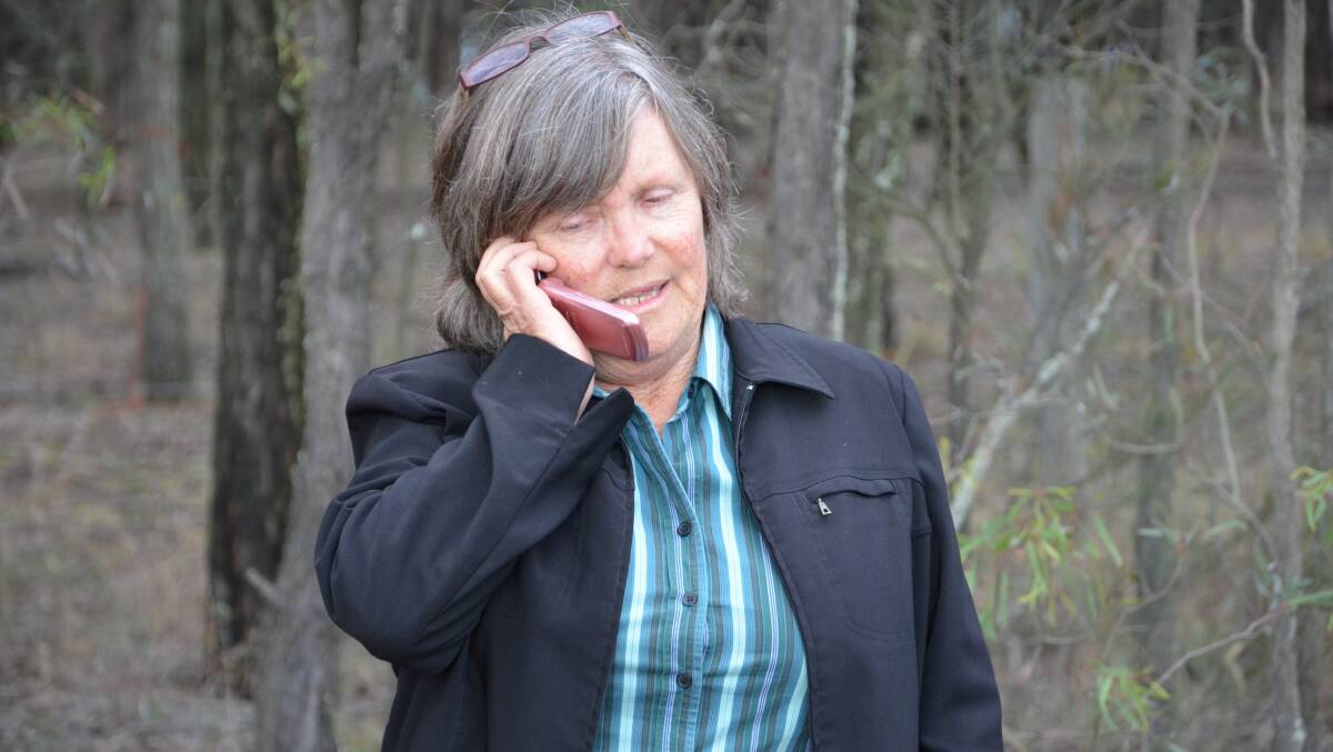 Hunter Environment Lobby member Bev Smiles takes the call  on her mobile with the news her group's court appeal against Ashton South East mine has been lost.