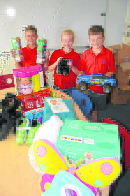 GENEROSITY: King Street Public School stage 3 students Madison Bendall, Josie Smith and Heath Russell with some of the items, which will assist the
residents of Dungog.
