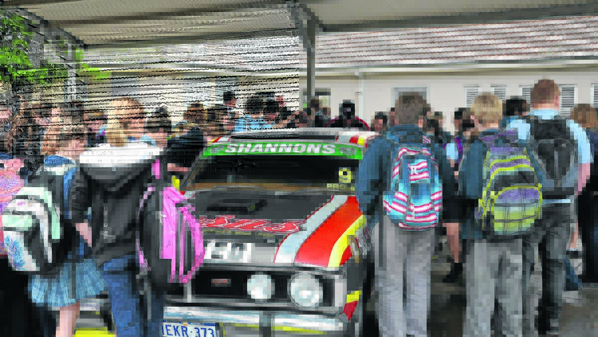 POPULAR:  Students gather to take a closer look at the replica car.
