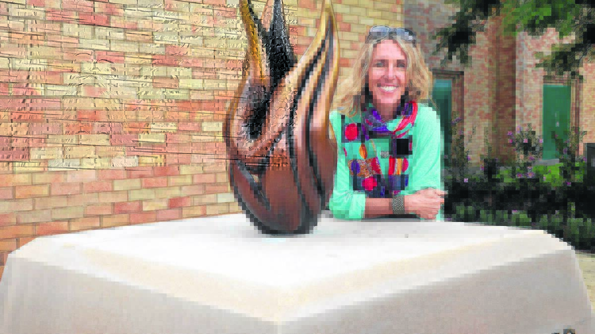 GREAT JOB: Sculptress Tanya Bartlett with the eternal flame.
