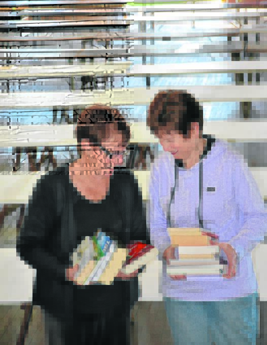 BOOK WORMS: Judy Langbien and Jenny Merrick from the Singleton Lions Club.