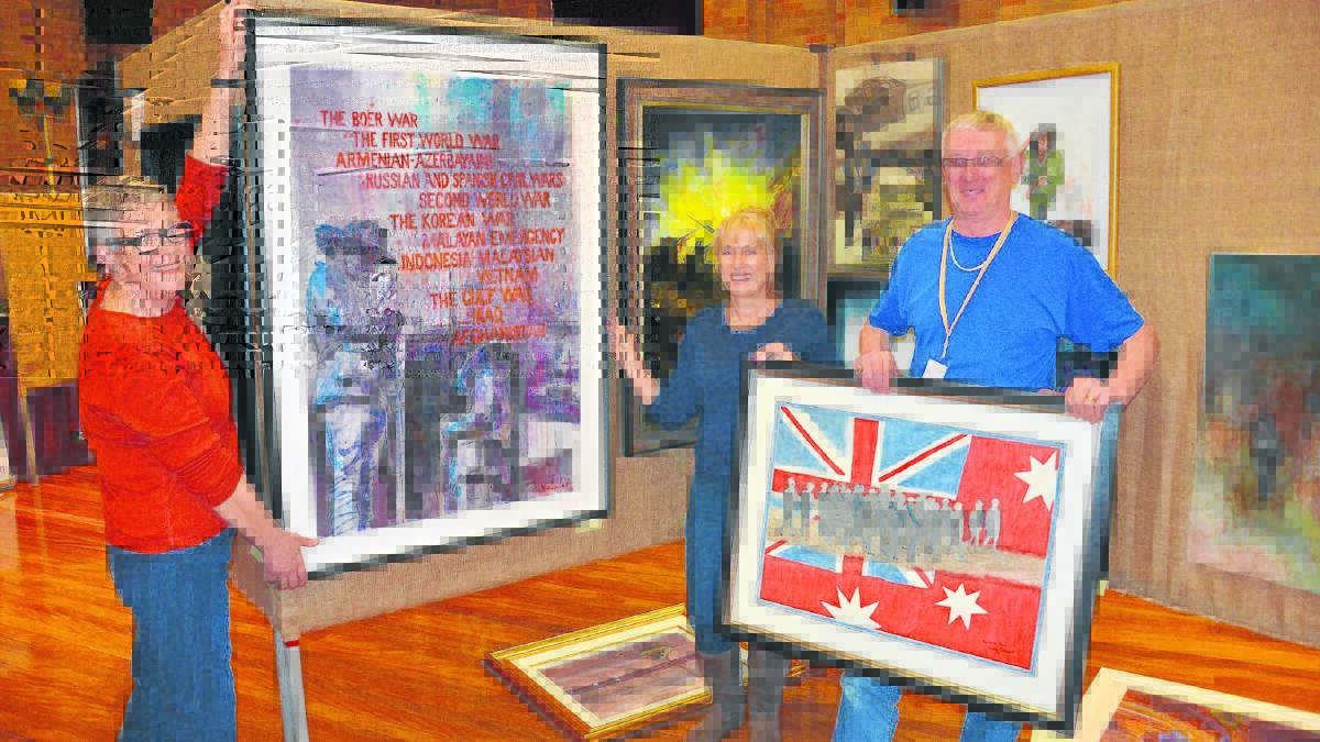 Nerina Gausden, Trish Patterson and David Gausden hanging works in the one-off-commemorative Anzac category.