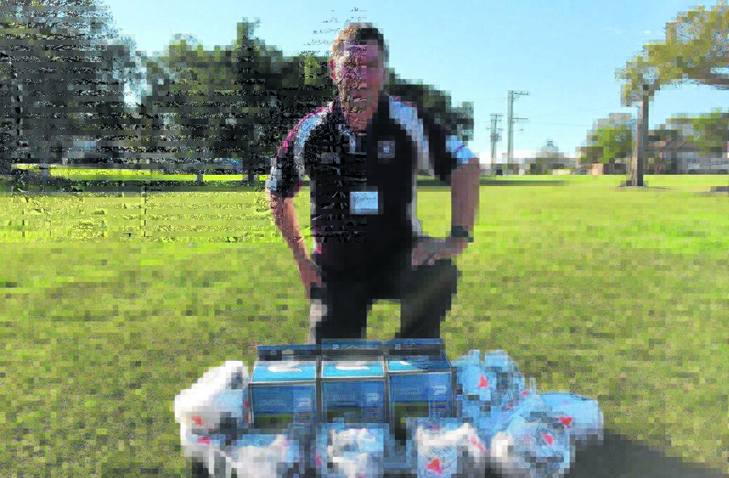 REWARD FOR ENGAGEMENT: Vice president of Singleton Strikers Mark Henderson with training gear the club was awarded.
