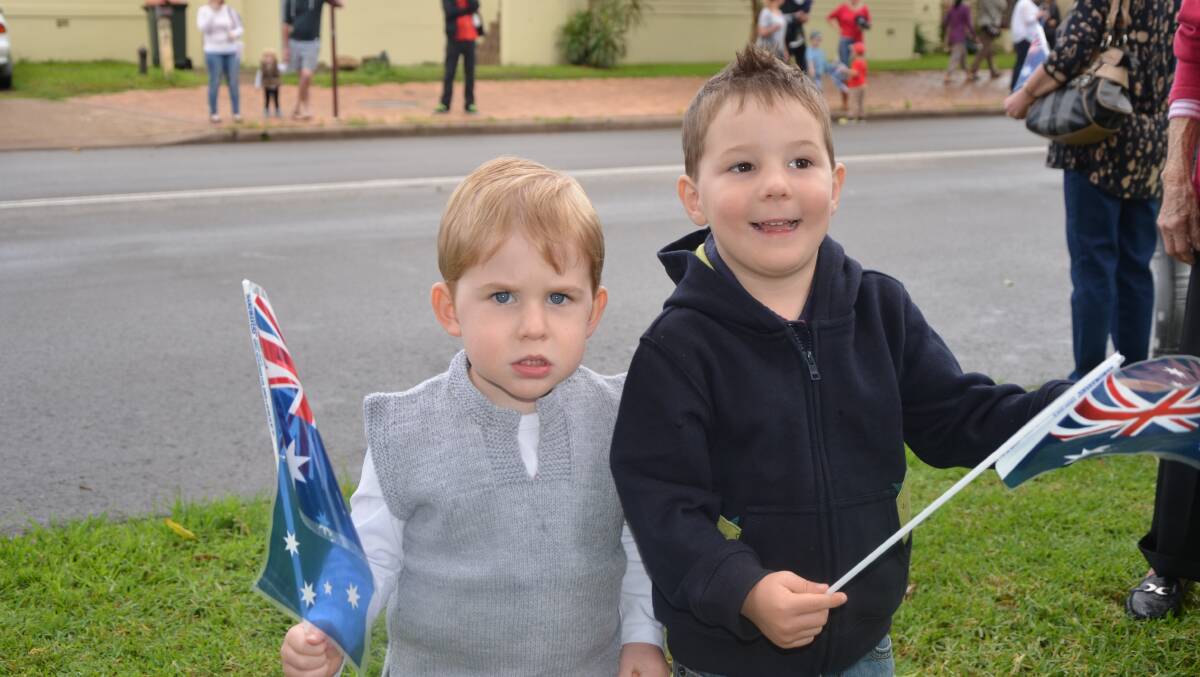 PATRIOTIC: Cousins Jack Thomas and Aidan Martin wave their Australian flags on Anzac Day. 
