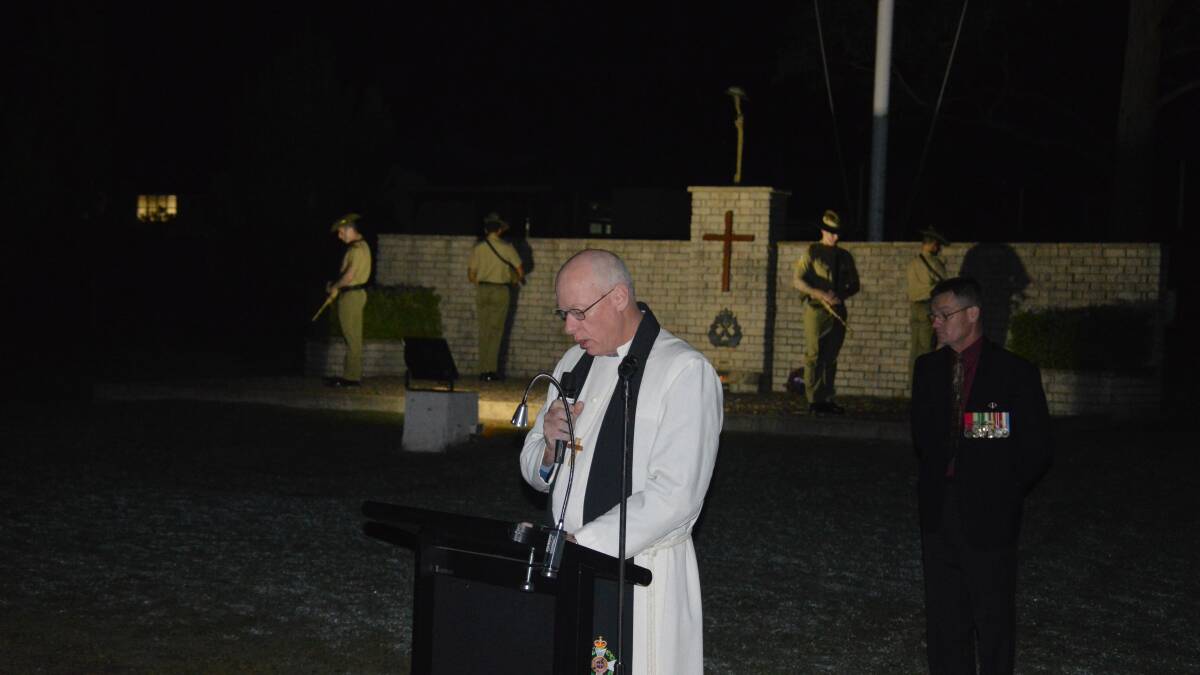 Chaplain Mark Hinton speaks a prayer at the dawn service at the Lone Pine Army Barracks.
